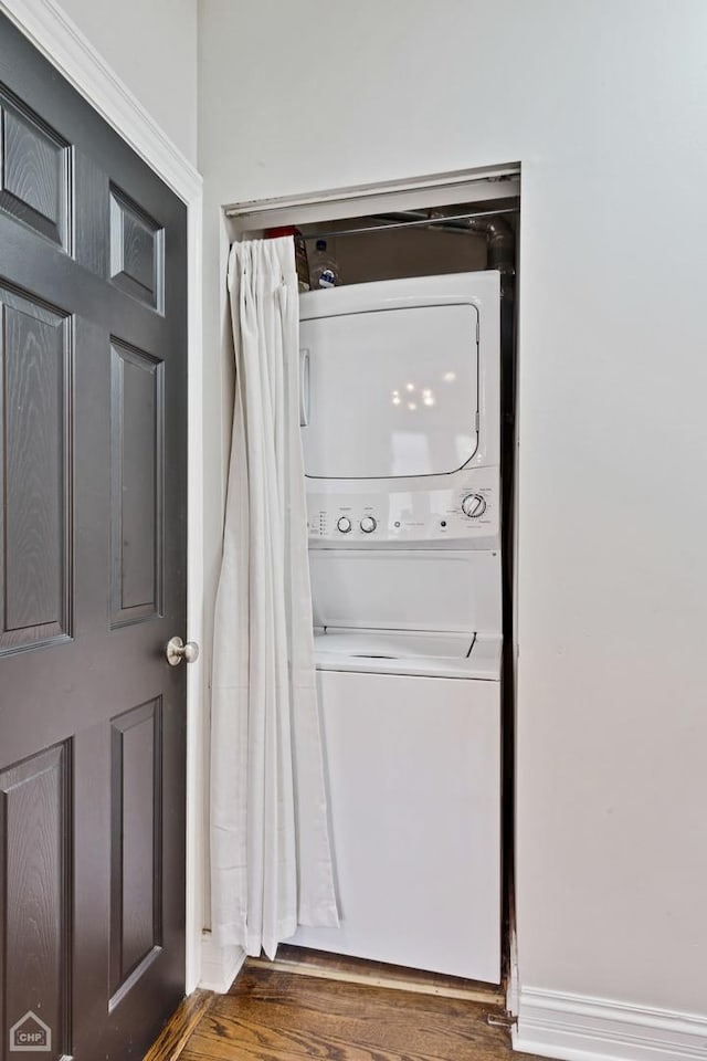 3608 W Dickens Ave Unit 2F, Chicago, IL 60647 - washroom featuring stacked washing machine and dryer and wood finished floors