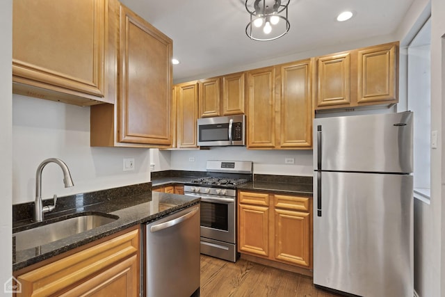 3608 W Dickens Ave Unit 2F, Chicago, IL 60647 - kitchen featuring stainless steel appliances, recessed lighting, dark stone countertops, and light wood-type flooring