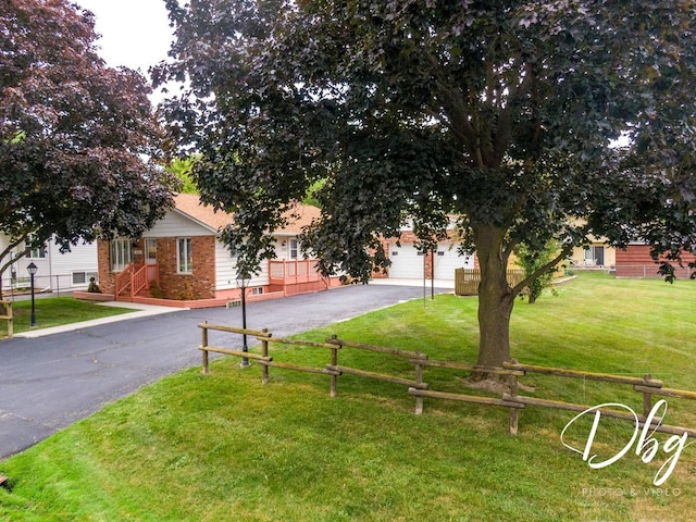 1323 Beverly Dr, Round Lake Beach, IL 60073 - view of front facade with asphalt driveway, brick siding, and a garage