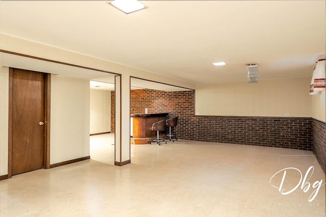 1323 Beverly Dr, Round Lake Beach, IL 60073 - finished below grade area featuring brick wall and tile patterned floors