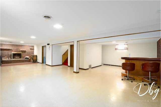 1323 Beverly Dr, Round Lake Beach, IL 60073 - finished below grade area with light floors, a bar, stairway, a fireplace, and recessed lighting