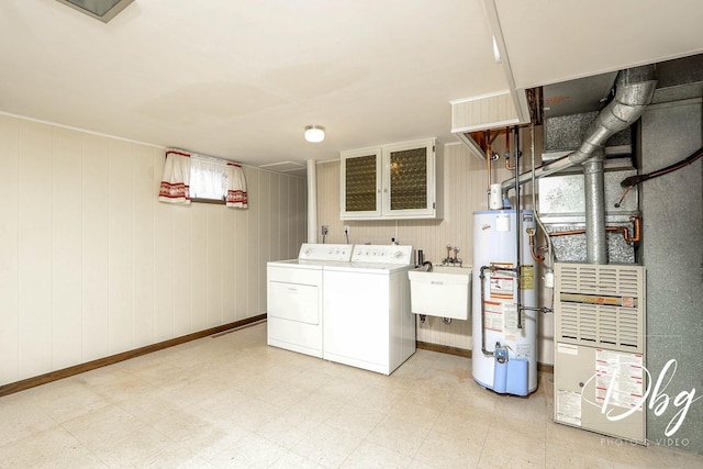 1323 Beverly Dr, Round Lake Beach, IL 60073 - laundry area with gas water heater, washing machine and clothes dryer, light flooring, and wooden walls