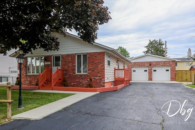 1323 Beverly Dr, Round Lake Beach, IL 60073 - view of front of property with an outdoor structure, brick siding, and a front lawn