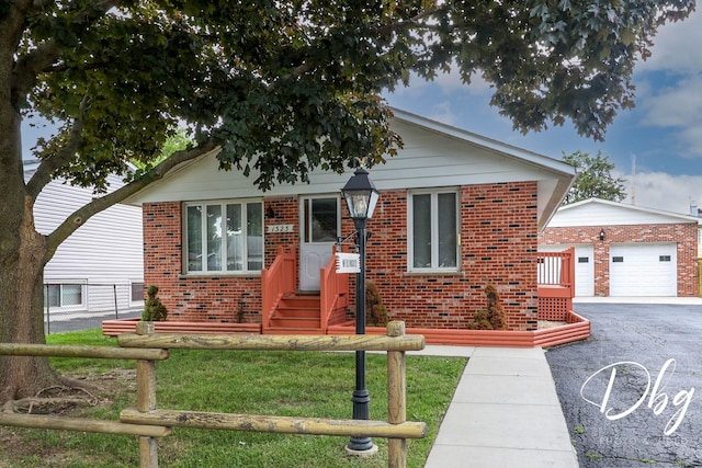 1323 Beverly Dr, Round Lake Beach, IL 60073 - bungalow-style home with brick siding, an outdoor structure, and driveway