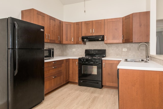 2060 Navarone Dr, Naperville, IL 60565 - kitchen featuring black appliances, under cabinet range hood, light wood finished floors, light countertops, and decorative backsplash