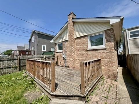 1340 Wesley Ave, Berwyn, IL 60402 - rear view of property featuring a chimney, a deck, a fenced backyard, and brick siding