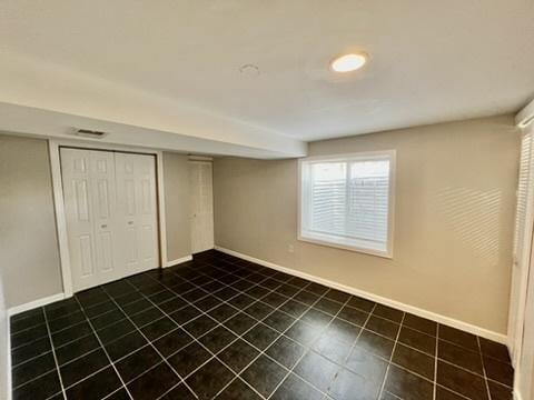 1340 Wesley Ave, Berwyn, IL 60402 - unfurnished bedroom with dark tile patterned floors and a closet