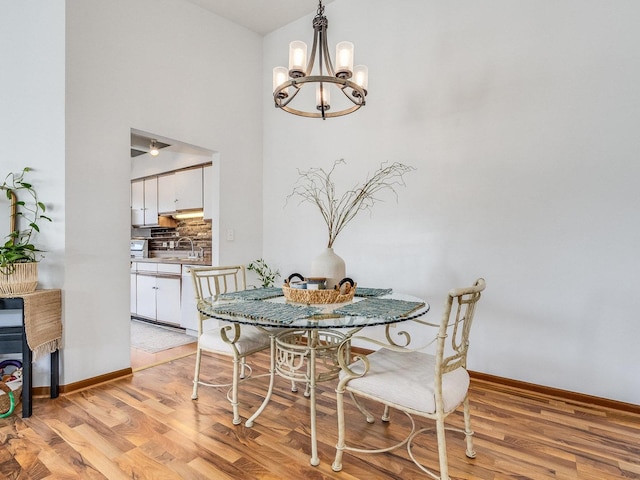 2326 Olde Mill Rd, Plainfield, IL 60586 - dining area with a chandelier, light wood-type flooring, and a high ceiling