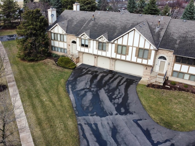2326 Olde Mill Rd, Plainfield, IL 60586 - tudor house featuring roof with shingles, a chimney, a garage, driveway, and brick siding