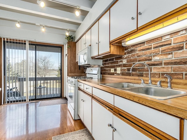 2326 Olde Mill Rd, Plainfield, IL 60586 - kitchen featuring white appliances, white cabinetry, track lighting, light wood-style flooring, and decorative backsplash