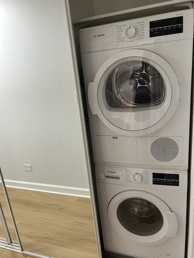 2426 N Kennicott Ave Unit 1D, Arlington Heights, IL 60004 - laundry area with stacked washer and clothes dryer and light wood-type flooring
