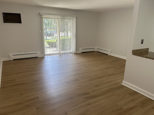 2426 N Kennicott Ave Unit 1D, Arlington Heights, IL 60004 - unfurnished room with a baseboard heating unit, dark wood-style flooring, and baseboard heating