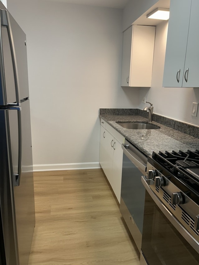 2426 N Kennicott Ave Unit 1D, Arlington Heights, IL 60004 - kitchen featuring stainless steel appliances, white cabinetry, light wood finished floors, and dark stone counters