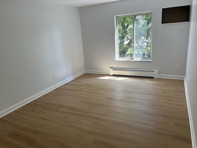 2426 N Kennicott Ave Unit 1D, Arlington Heights, IL 60004 - unfurnished room featuring baseboard heating and wood finished floors