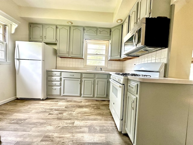 316 N Worth Ave, Elgin, IL 60123 - kitchen featuring white appliances, green cabinets, light wood finished floors, and backsplash