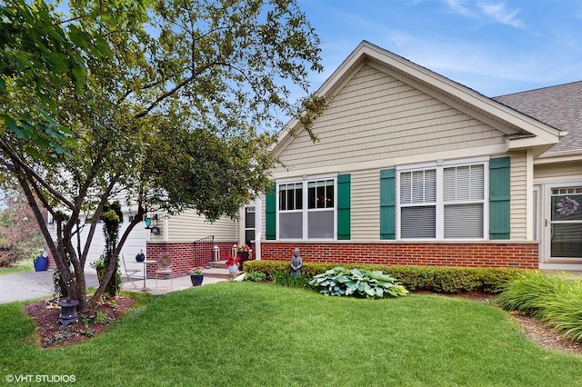 301 W Eagle Ct, Waukegan, IL 60087 - view of front facade featuring brick siding, a front yard, and driveway