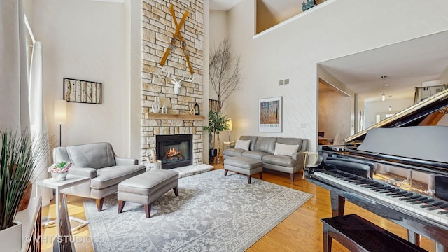 301 W Eagle Ct, Waukegan, IL 60087 - living area featuring wood finished floors, a stone fireplace, and a high ceiling