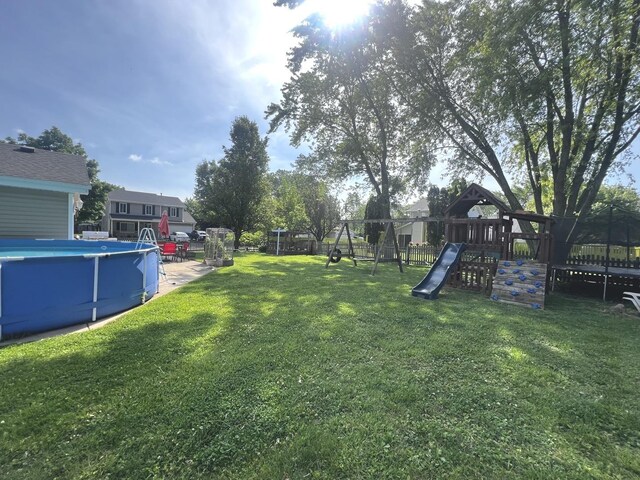 2945 Worcester Ln, Aurora, IL 60504 - view of yard featuring a playground, an outdoor pool, and a trampoline