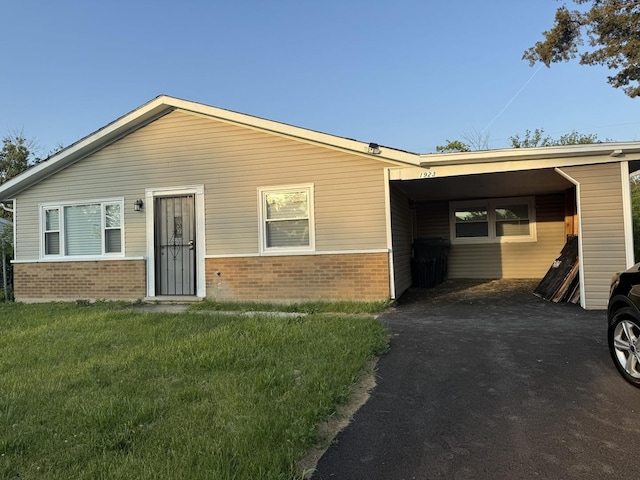 1923 Revere St, Chicago Heights, IL 60411 - view of front facade featuring brick siding, a front lawn, and asphalt driveway