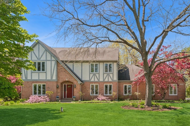 21705 W Hilandale Ct, Kildeer, IL 60047 - tudor house featuring a front yard, brick siding, stucco siding, and a shingled roof