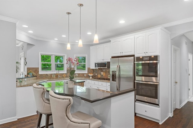 21705 W Hilandale Ct, Kildeer, IL 60047 - kitchen featuring stainless steel appliances, white cabinetry, dark wood-style floors, ornamental molding, and recessed lighting
