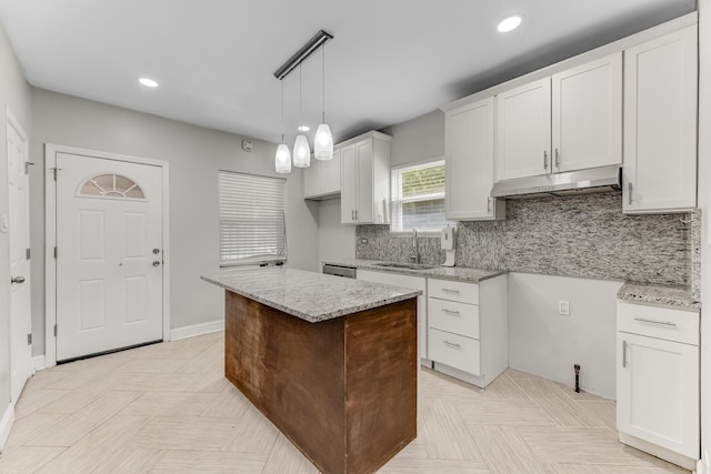 7125 S Sangamon St, Chicago, IL 60621 - kitchen with under cabinet range hood, light stone countertops, tasteful backsplash, recessed lighting, and white cabinetry