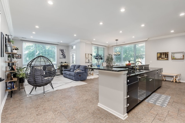 1825 N Winnebago Ave Unit 101, Chicago, IL 60647 - kitchen featuring crown molding, an island with sink, dishwasher, healthy amount of natural light, and open floor plan