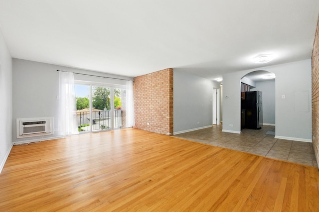 9516 S Kildare Ave Unit 3S, Oak Lawn, IL 60453 - unfurnished living room with wood finished floors, arched walkways, and a wall mounted air conditioner
