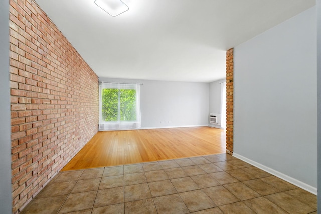 9516 S Kildare Ave Unit 3S, Oak Lawn, IL 60453 - spare room featuring brick wall, tile patterned flooring, and an AC wall unit