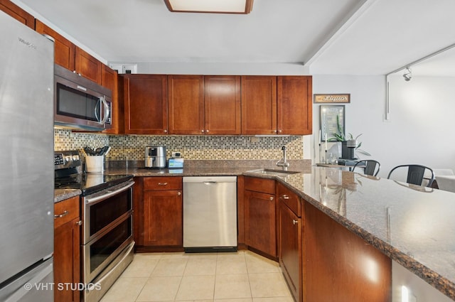 525 W Hawthorne Pl Unit 1004, Chicago, IL 60657 - kitchen with appliances with stainless steel finishes, decorative backsplash, rail lighting, dark stone countertops, and light tile patterned floors