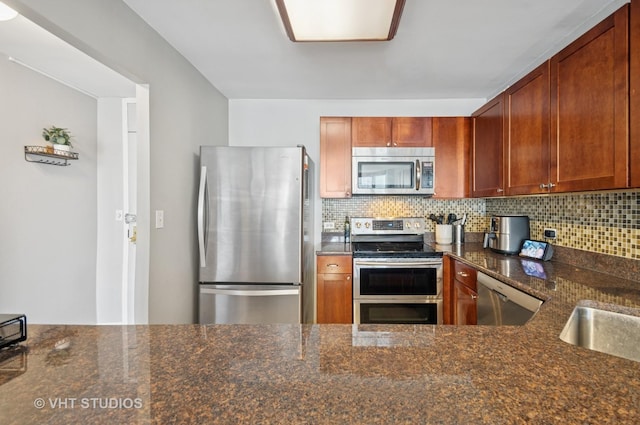 525 W Hawthorne Pl Unit 1004, Chicago, IL 60657 - kitchen featuring stainless steel appliances, decorative backsplash, and dark stone countertops