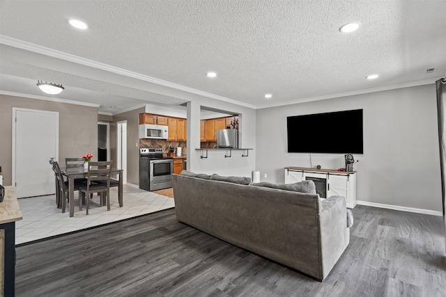 10622 Parkside Ave Unit 103, Chicago Ridge, IL 60415 - living area featuring light wood-style flooring, recessed lighting, a textured ceiling, and crown molding