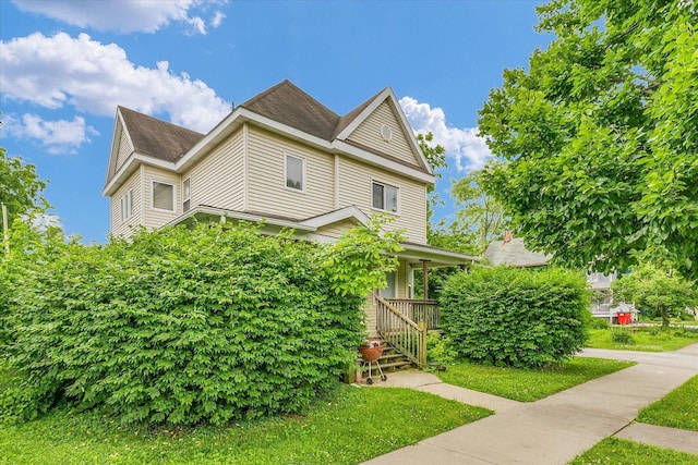 611 W White St, Champaign, IL 61820 - view of front of property with a front yard and a shingled roof