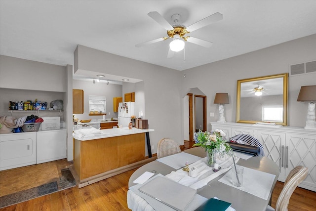 611 W White St, Champaign, IL 61820 - dining room featuring independent washer and dryer, a ceiling fan, wood finished floors, and healthy amount of natural light