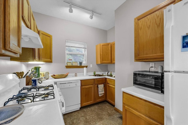 611 W White St, Champaign, IL 61820 - kitchen with white appliances, under cabinet range hood, rail lighting, light countertops, and brown cabinets
