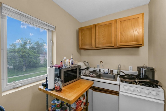 611 W White St, Champaign, IL 61820 - kitchen featuring stainless steel microwave, electric range, light countertops, and brown cabinetry