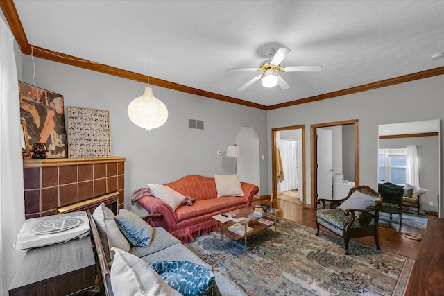 611 W White St, Champaign, IL 61820 - living room featuring wood finished floors, a ceiling fan, and ornamental molding