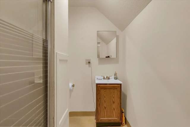 611 W White St, Champaign, IL 61820 - bathroom featuring vanity, vaulted ceiling, and tile patterned floors