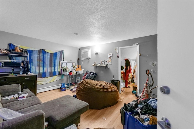 611 W White St, Champaign, IL 61820 - living room with wood finished floors, a textured ceiling, and a wall mounted AC