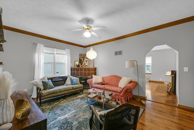 611 W White St, Champaign, IL 61820 - living area with ceiling fan, arched walkways, healthy amount of natural light, wood finished floors, and crown molding