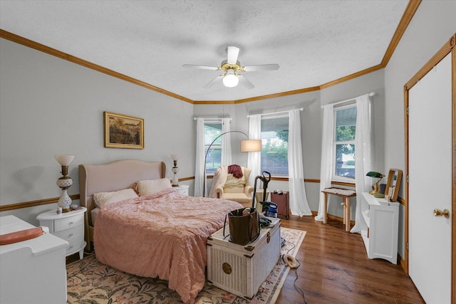 611 W White St, Champaign, IL 61820 - bedroom with wood finished floors, a textured ceiling, crown molding, and ceiling fan
