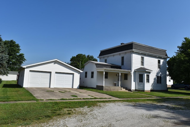 207 State St, Benson, IL 61516 - view of front of house featuring an outbuilding, a detached garage, and a front yard
