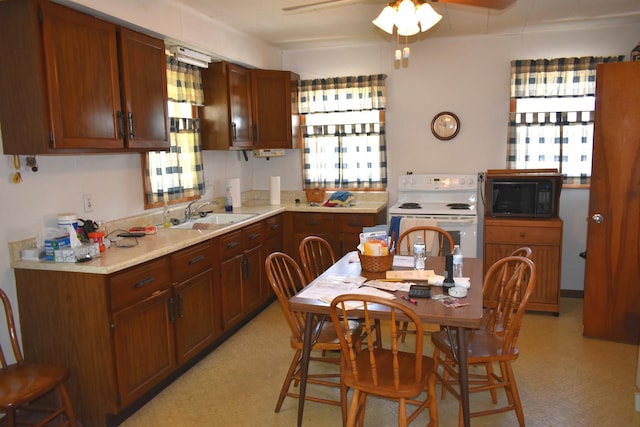 207 State St, Benson, IL 61516 - kitchen featuring black microwave, white electric range, healthy amount of natural light, and light floors