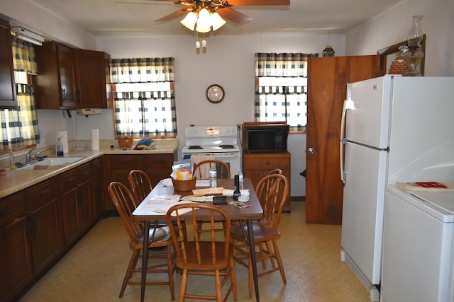 207 State St, Benson, IL 61516 - kitchen featuring white appliances, washer / dryer, ceiling fan, light countertops, and light floors
