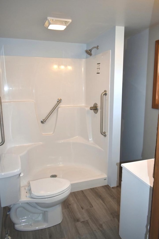 207 State St, Benson, IL 61516 - bathroom featuring wood finished floors, a walk in shower, and vanity
