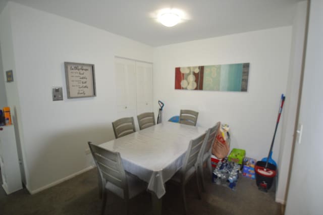1455 N Winslowe Dr Unit 302, Palatine, IL 60074 - dining room with dark carpet and baseboards