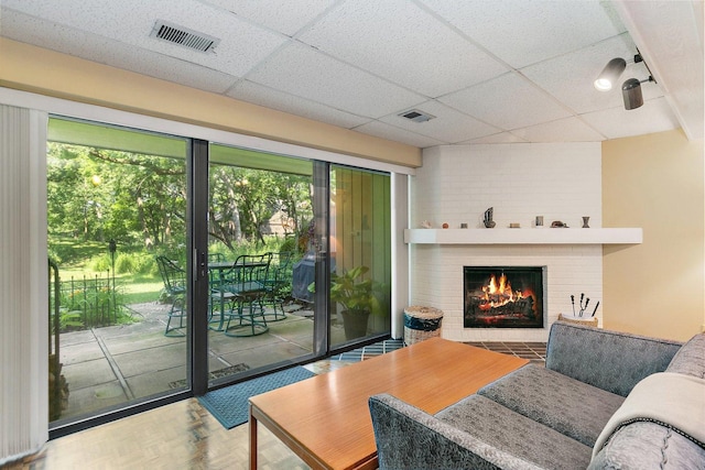 434C Woodview Rd Unit C, Lake Barrington, IL 60010 - living area featuring a drop ceiling and a brick fireplace