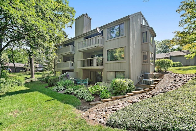 434C Woodview Rd Unit C, Lake Barrington, IL 60010 - rear view of property featuring a chimney, a yard, and a balcony