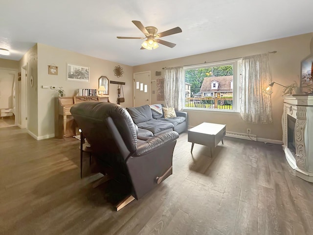 1639 S Highland Ave, Freeport, IL 61032 - living area featuring wood finished floors, a ceiling fan, a baseboard radiator, and a fireplace