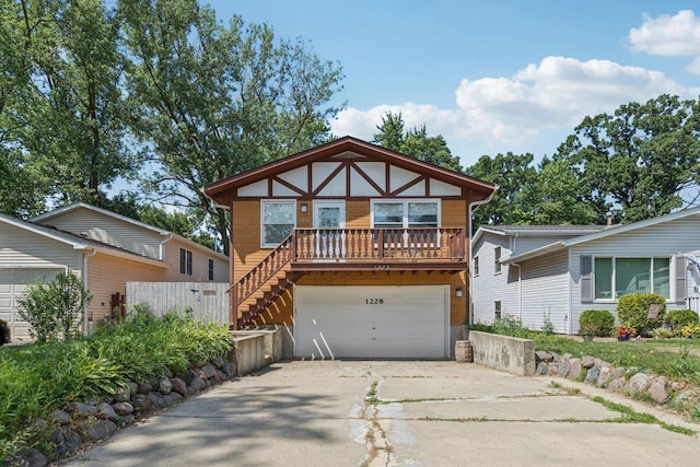 1228 N Lake Shore Dr, Round Lake Beach, IL 60073 - view of front of house with concrete driveway, an attached garage, and stairs